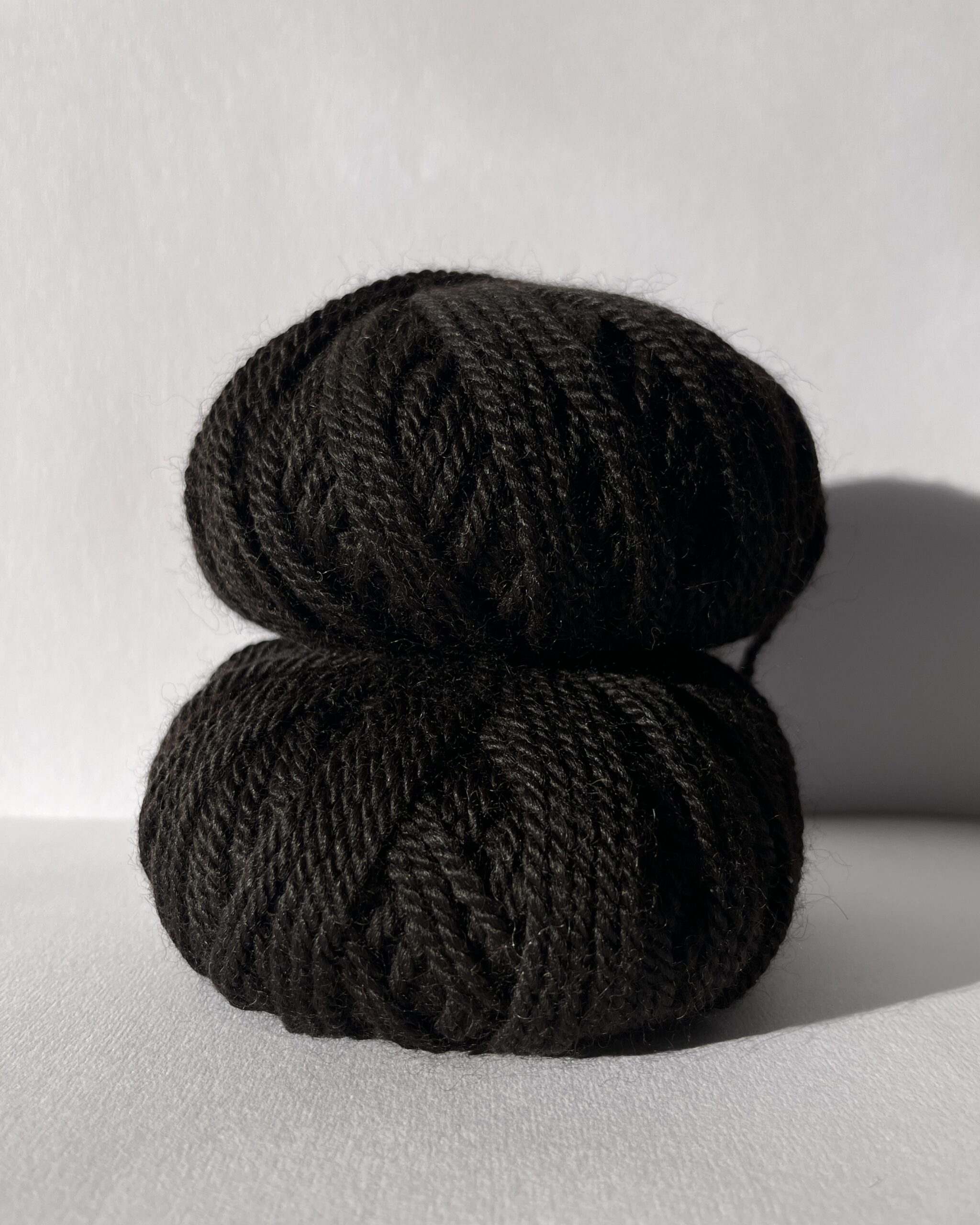 Undyed British alpaca yarn in deep Bay Black with warm brown undertones