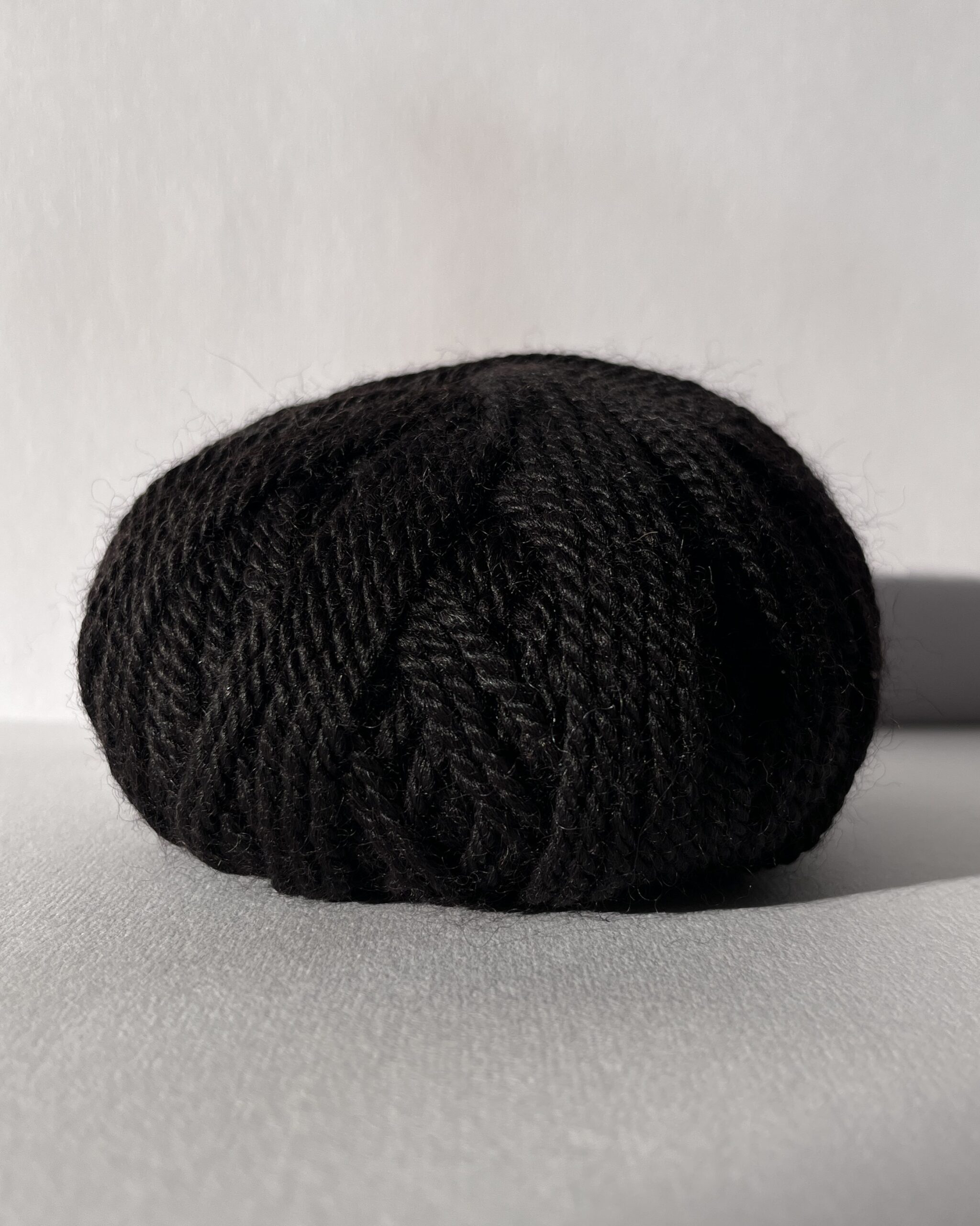Redens Bay Black 100% British alpaca Aran yarn in natural undyed near-black