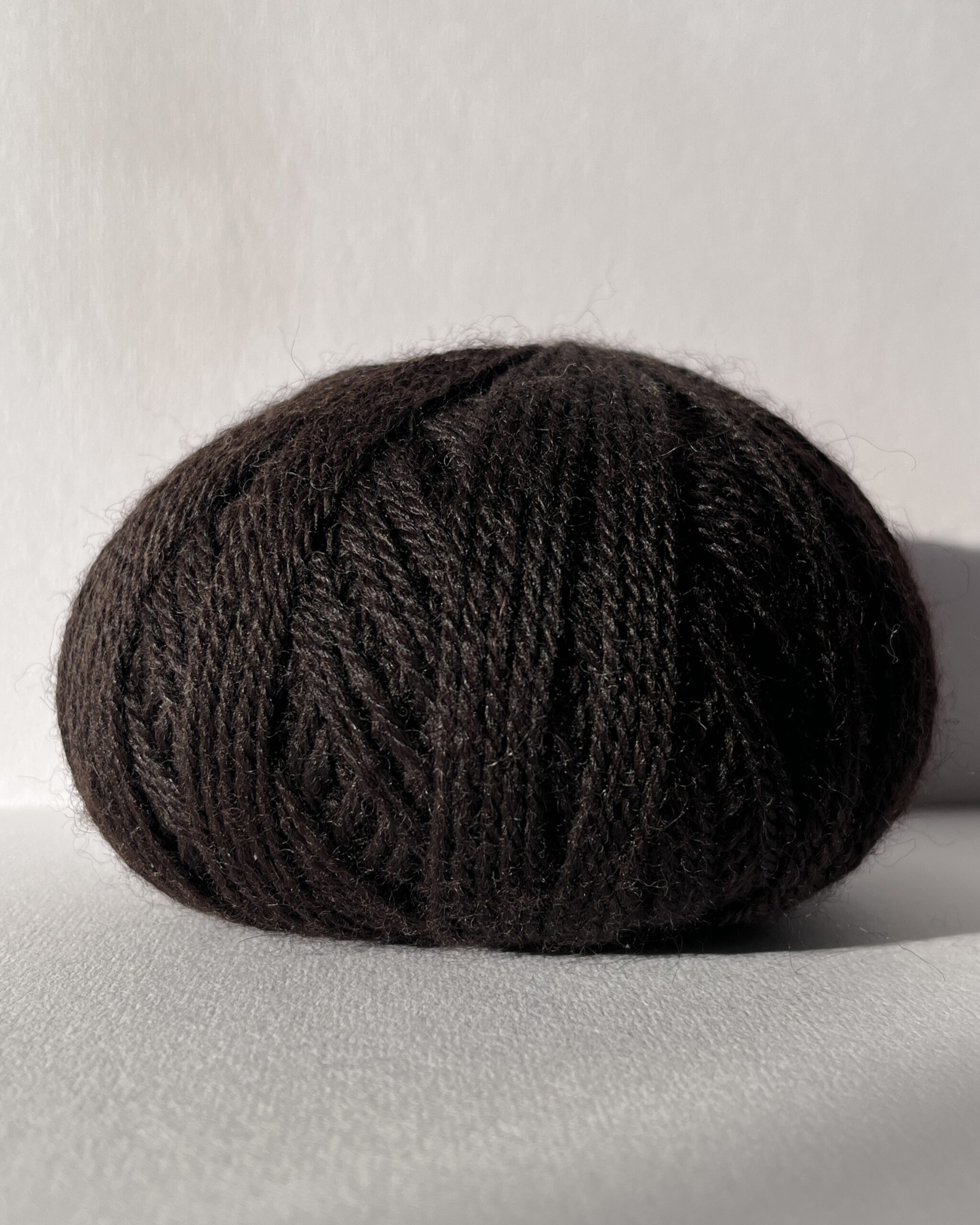 Redens Dark Brown British alpaca yarn close-up showing natural undyed colour